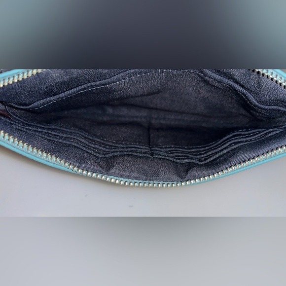 Stylish Coach wristlet in a deep dark blue color with a sleek design. - Picture 7 of 7